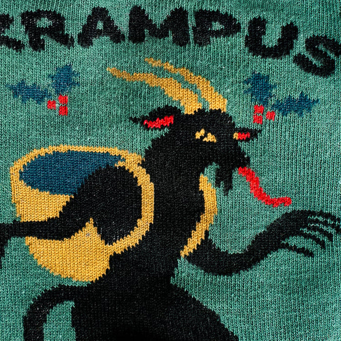Close-up detail shot highlighting the Krampus illustration on the socks.