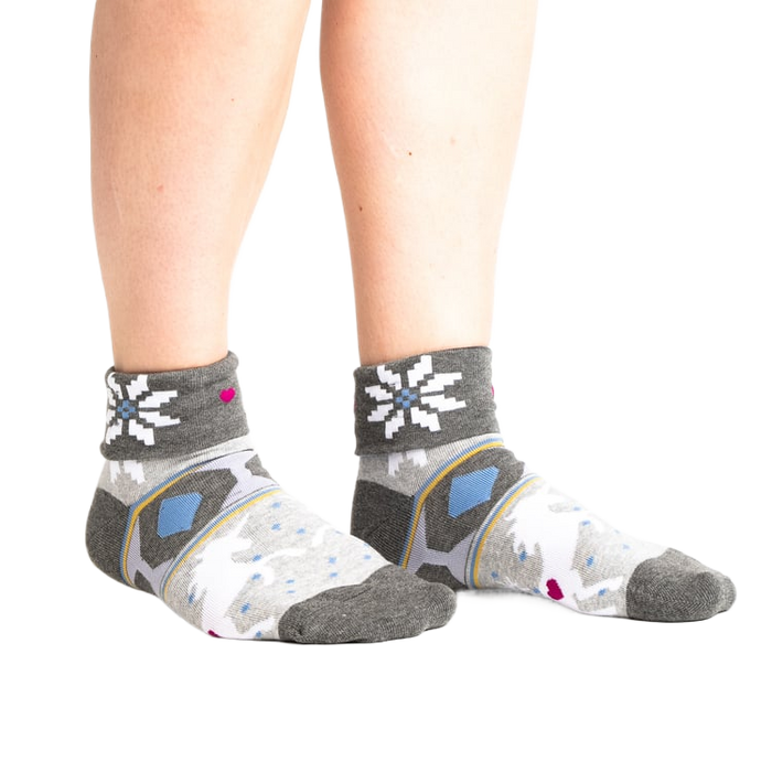 Lifestyle shot: Model wearing the grey and white 'I Believe in Sweater Weather' turn-cuff socks.