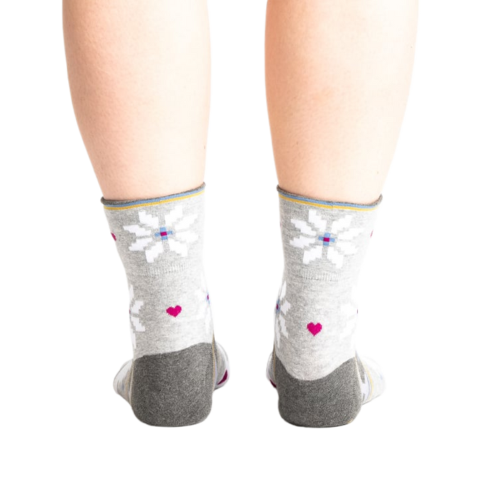 Back view of the socks on a model, showing the design detail on the heel and cuff.