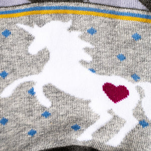 Close-up detail shot: Focusing on the white unicorn design with a pink heart on the sock.