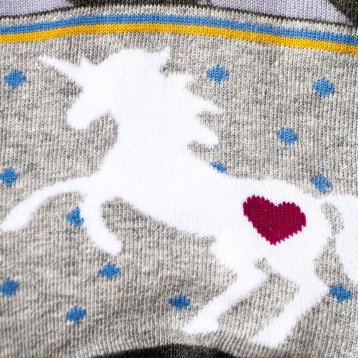 Close-up detail shot: Focusing on the white unicorn design with a pink heart on the sock.