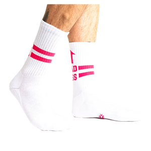 Lifestyle shot showing white Bad Ass Athletic Ribbed socks on a person's legs.