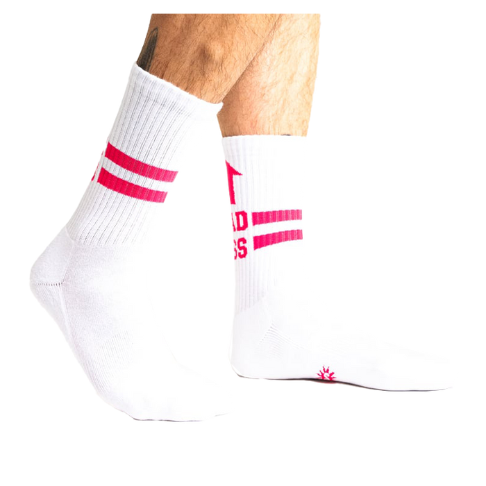 Lifestyle shot showing white Bad Ass Athletic Ribbed socks on a person's legs.