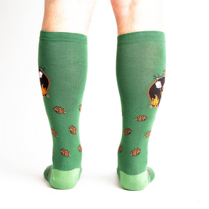 Rear view of a person wearing the 'S'more Where That Came From' knee-high socks, showing the full design on both socks.