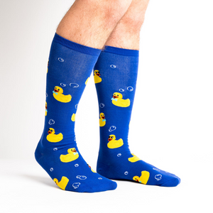 Lifestyle photo: A model's legs showing off the blue rubber duckie socks.