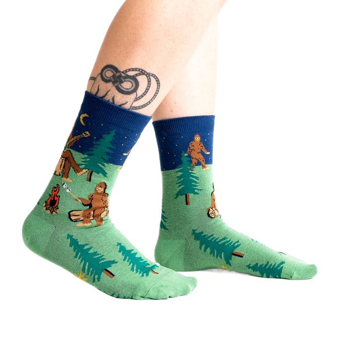 Lifestyle shot of Sasquatch Campout socks on a person's legs.