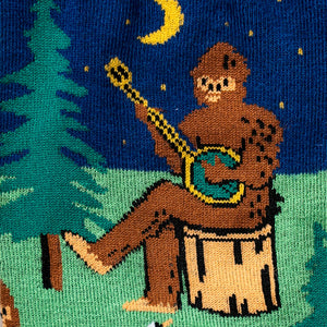Close-up detail shot showcasing the Bigfoot playing a banjo on the Sasquatch Campout socks.