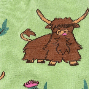 Close-up detail shot of the Highland cow and thistle pattern on the sock fabric.