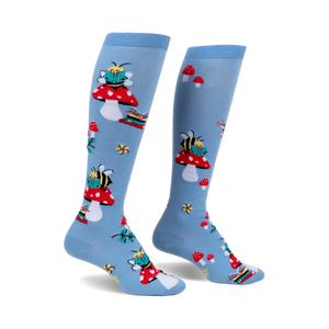 Pair of light blue knee-high socks with a whimsical design featuring bees reading books perched on red mushrooms.