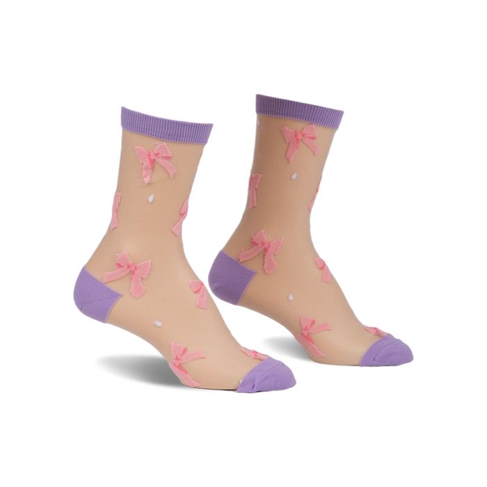 Pair of sheer beige ankle socks with pink bows and lavender cuffs.  Small white polka dots are scattered across the socks.