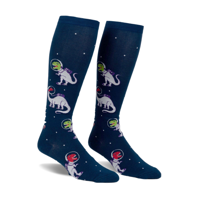 Pair of navy blue knee-high socks with a repeating pattern of white and purple dinosaurs wearing astronaut helmets in space.