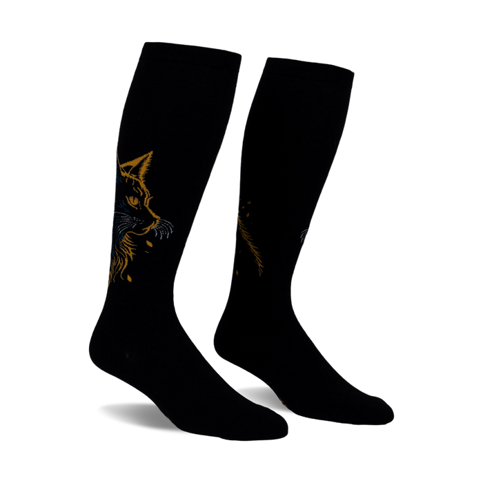 Pair of black knee-high socks with a gold and blue cat design. The cat's face is prominently featured on each sock.