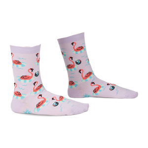 Pair of lavender crew socks with a fun flamingo design. Flamingos float on inflatable rings against a light purple background.