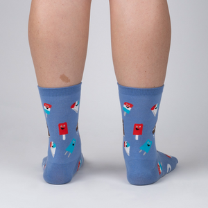 Back view of periwinkle blue crew socks with ice cream pattern on a person's legs.