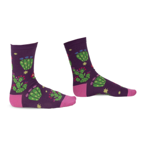 Pair of purple crew socks with a whimsical cactus and flower design. Pink accents at the heel and toe.