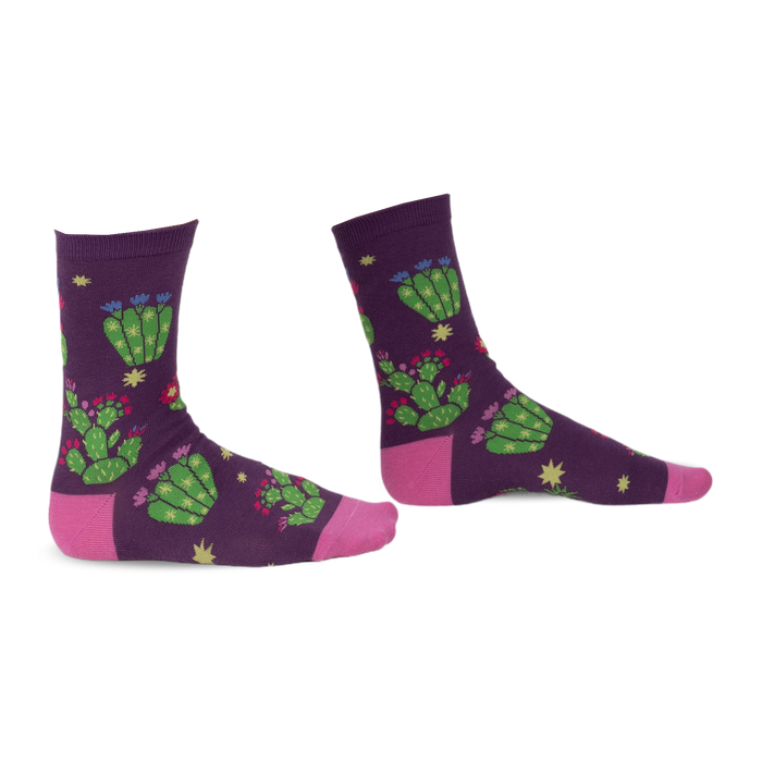 Pair of purple crew socks with a whimsical cactus and flower design. Pink accents at the heel and toe.