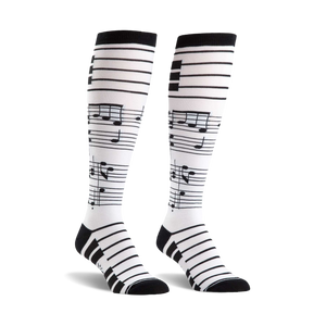 Pair of black and white knee-high socks.  The socks have a musical staff and notes design.