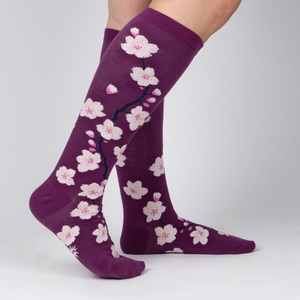 Lifestyle shot of Cherry Blossom socks on a woman's legs.