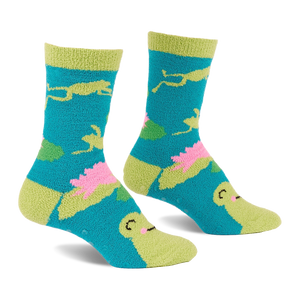 Pair of fuzzy teal blue slipper socks with lime green jumping frogs, pink lily pads, and frog faces on toes.