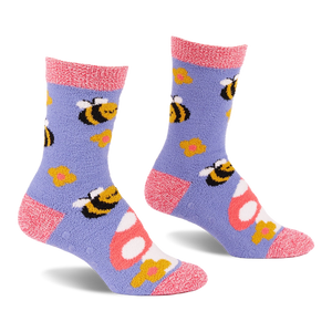 Pair of fuzzy periwinkle slipper socks with pink cuffs, heels, and toes, patterned with yellow bees, mushrooms, and flowers.