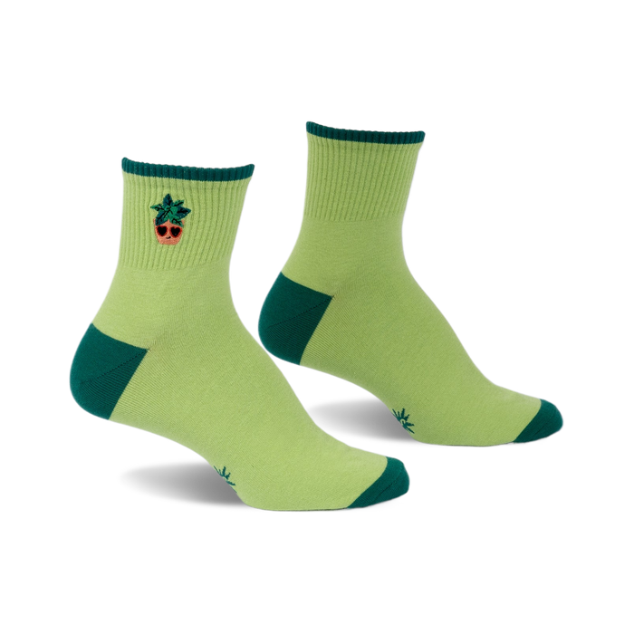 Pair of lime green ankle socks with a small embroidered potted plant design and hunter green accents at the heel and toe.