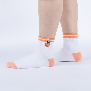 Lifestyle shot showing the socks on a person's feet against a white background.