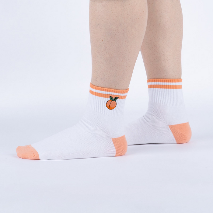 Lifestyle shot showing the socks on a person's feet against a white background.
