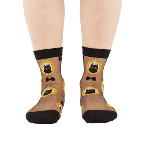 Full frontal view of a person's lower legs and feet wearing the sheer black cat socks on a white background.