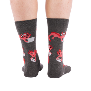 Full-length shot of a person's legs, viewed from the back, wearing grey axolotl gaming crew socks on a white background.