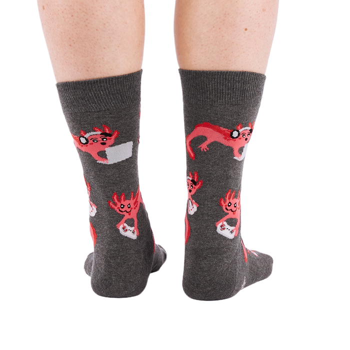 Full-length shot of a person's legs, viewed from the back, wearing grey axolotl gaming crew socks on a white background.