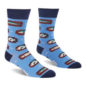 Pair of light blue crew socks with a repeating pattern of fish on brown rectangular shapes and white knot designs.
