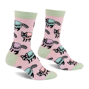 Pair of pink crew socks with light green accents, featuring a repeating pattern of cartoon raccoons and pastel macarons.
