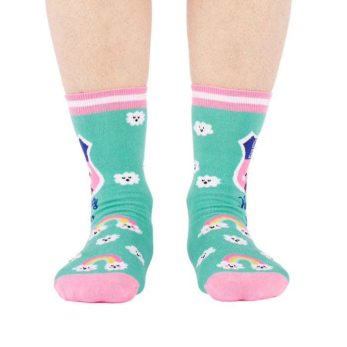 Front view of a person's legs wearing teal 'Hiking Club' crew socks. Both socks display the cloud pattern and 'Out of Breath' text.