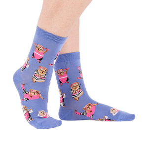 Person's feet wearing periwinkle crew socks with a guinea pig workout pattern, viewed from the side on white.