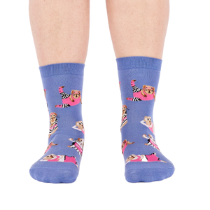 Person's feet wearing periwinkle crew socks with a guinea pig workout pattern, viewed from the front on white.