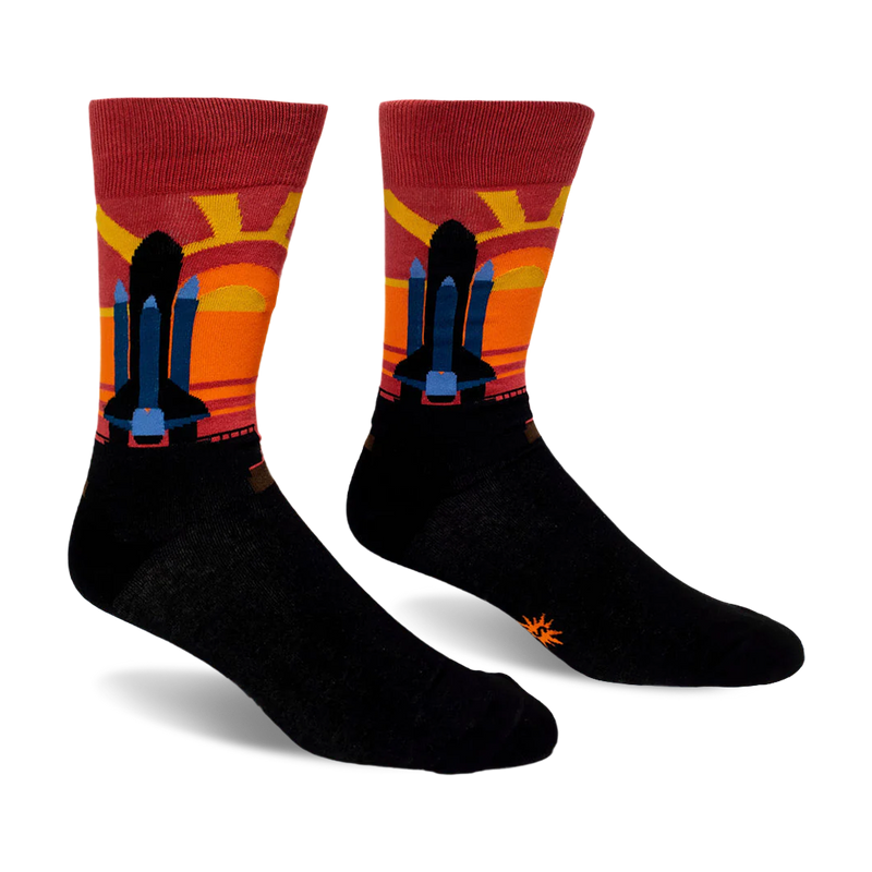 Black crew socks featuring a space shuttle silhouette against a striped maroon, red, orange, and yellow sunset background.