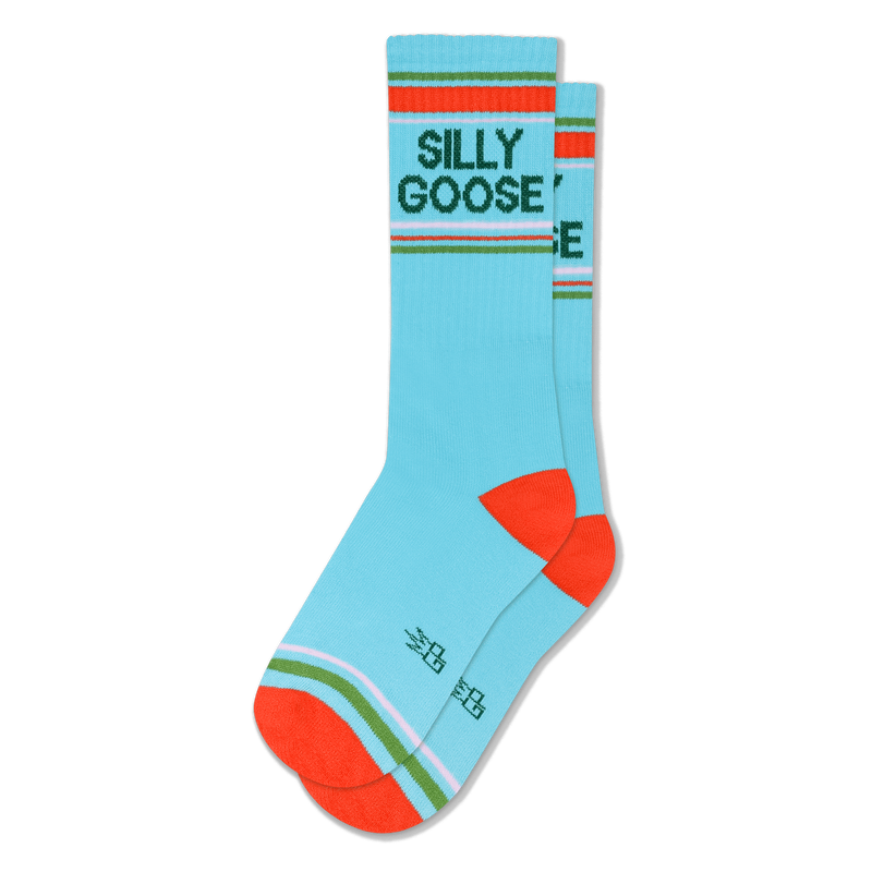 Light blue crew socks with dark green SILLY GOOSE text, orange heels and toes, and sporty striped accents near the cuff.