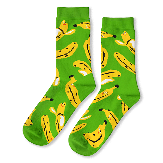 Bright green crew socks covered in a pattern of yellow bananas with tiny smiling faces, some peeled and some unpeeled.