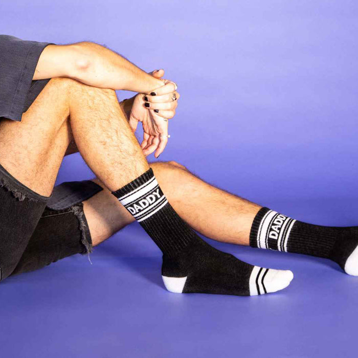 Lifestyle shot: Close-up on a man's legs, wearing the socks, showing the detailing.