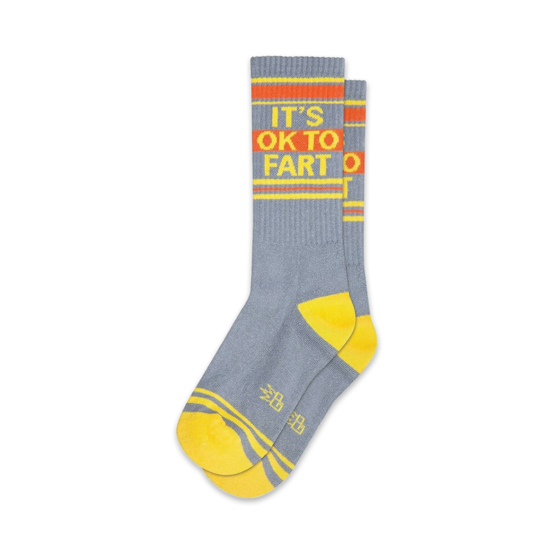 Pair of gray crew socks with yellow and orange stripes and the phrase 'It's Ok to Fart'.