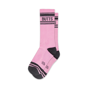 Pair of pink crew socks with black stripes and 'BUTTS' written across the top. Fun, casual style.