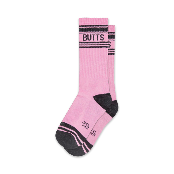 Pair of pink crew socks with black stripes and 'BUTTS' written across the top. Fun, casual style.