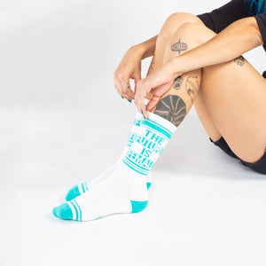 Lifestyle shot of a person's legs wearing the 'The Future is Female' socks.