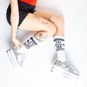 Lifestyle shot: Person wearing white 'I'd Fuck Me' socks with silver platform shoes.