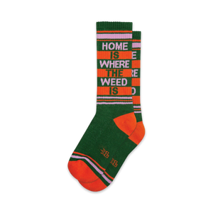Pair of crew socks in green, orange, and purple.  Features a retro-style stripe pattern and the text 'Home Is Where The Weed Is'.