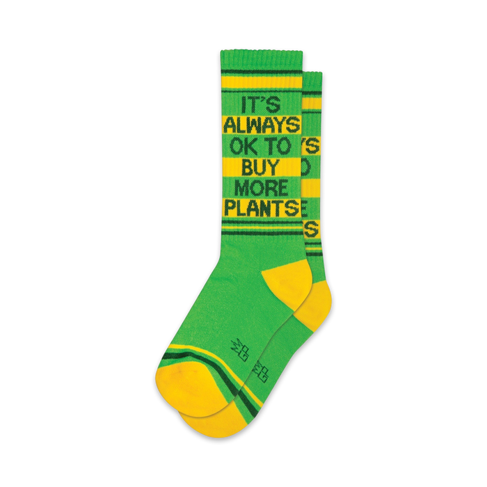 green and yellow crew socks for men and women with the saying 'it's always ok to buy more plants.'  