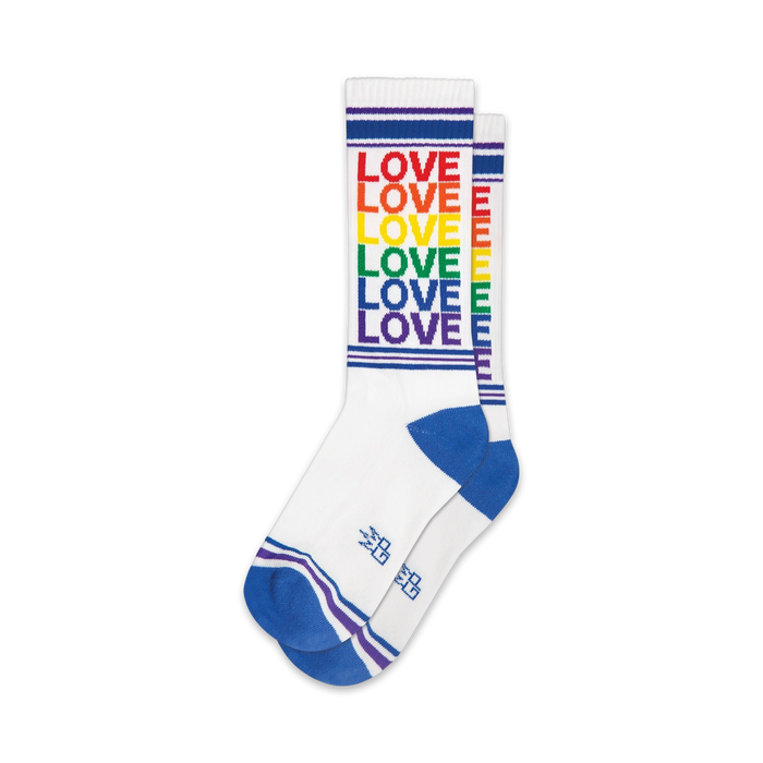 Pair of white crew socks with rainbow or brown 'LOVE' vertical stripes and blue/brown cuffs.