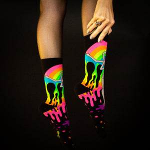 Lifestyle shot: 'Derriere of Doom' socks on a model's legs against a dark background.