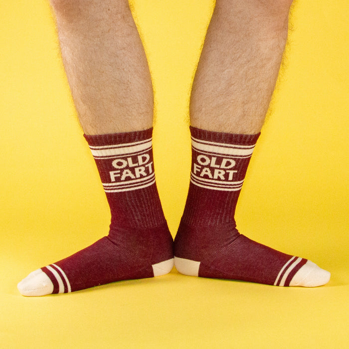 Front-on shot of a pair of legs wearing the maroon and cream 'Old Fart' socks.