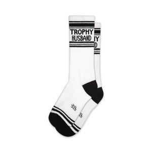 Pair of white crew socks with black stripes and 'Trophy Husband' text.